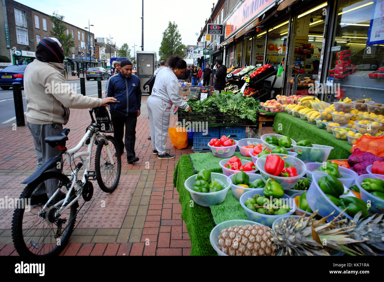 customers-choosing-fruit-veg-displayed-outside-shop-in-luton