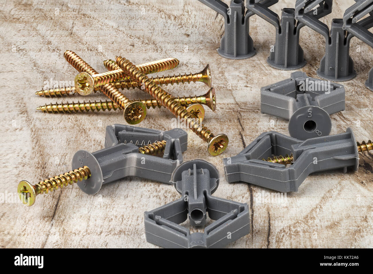 Plastic dowel with a screw for mounting on a wooden table. Closeup