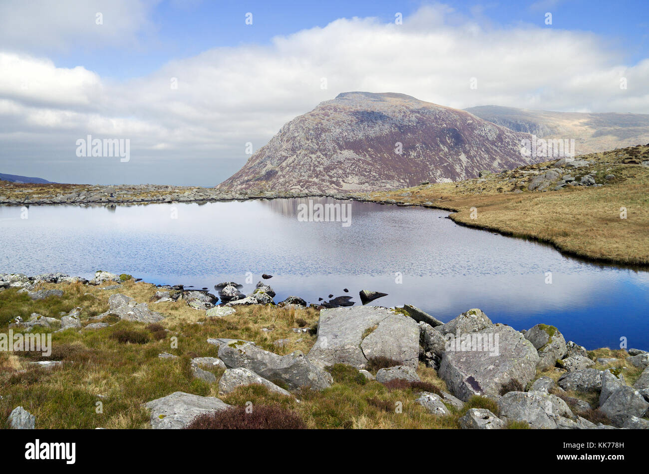 Llyn (Lake) Bochlwyd is a wild, rugged mountain lake in Snowdonia. It is in the Glyderau range and offers excellent views of the surrounding mountains. Stock Photo