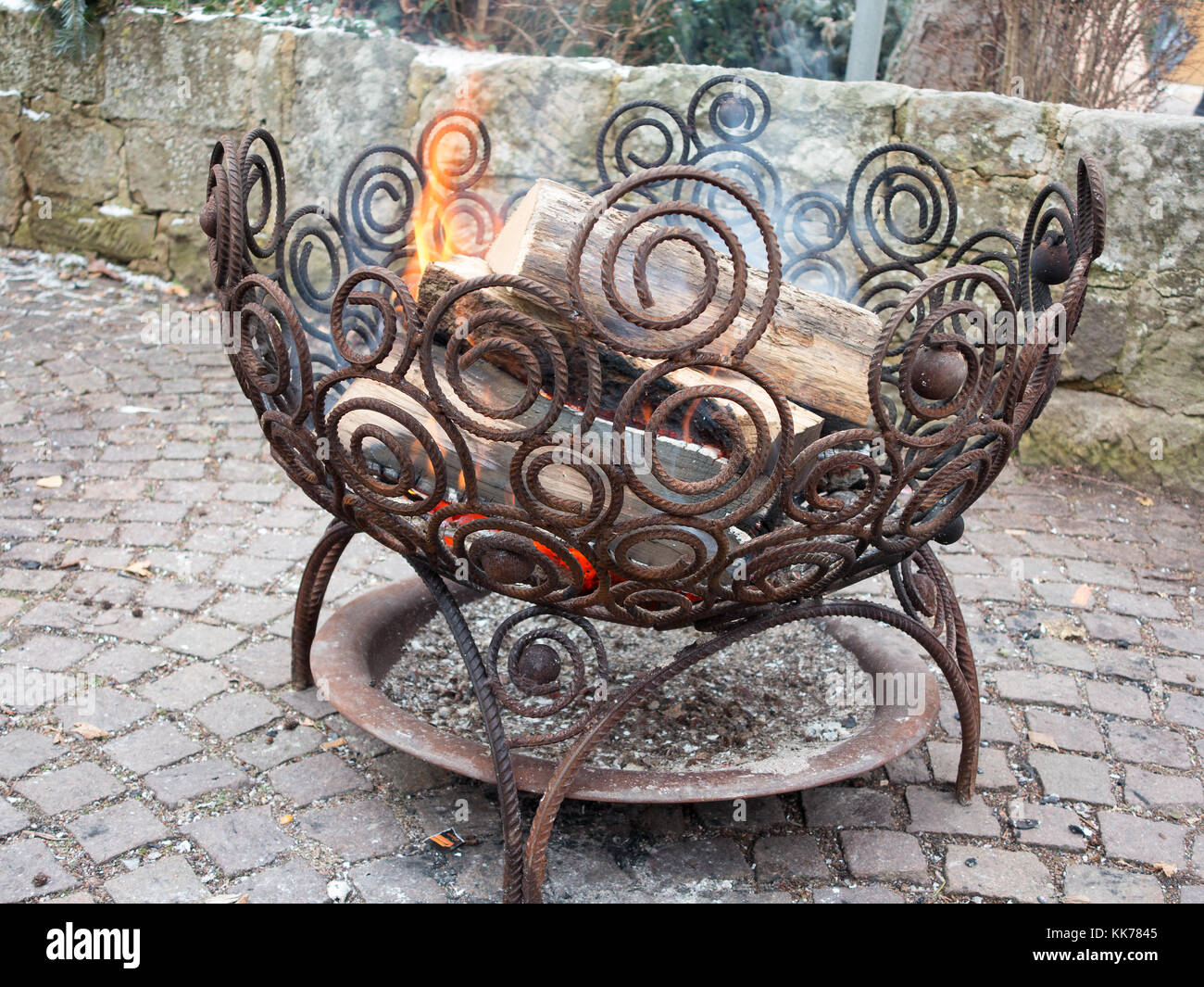 Outdoor fire place in an iron basket Stock Photo
