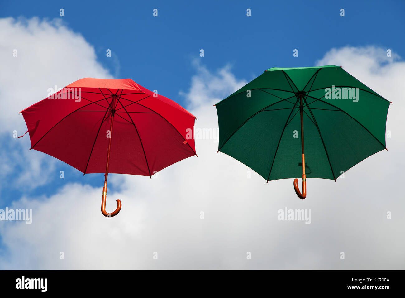 Two Floating Umbrellas in Red and Green Stock Photo