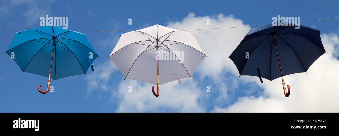 Hanging Umbrellas in Blue, White and Dark Blue Stock Photo