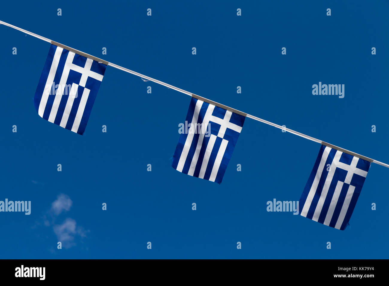 Festoon sling with 3 Greek flags, spotted in a Greek Cypriot village on Cyprus. Stock Photo
