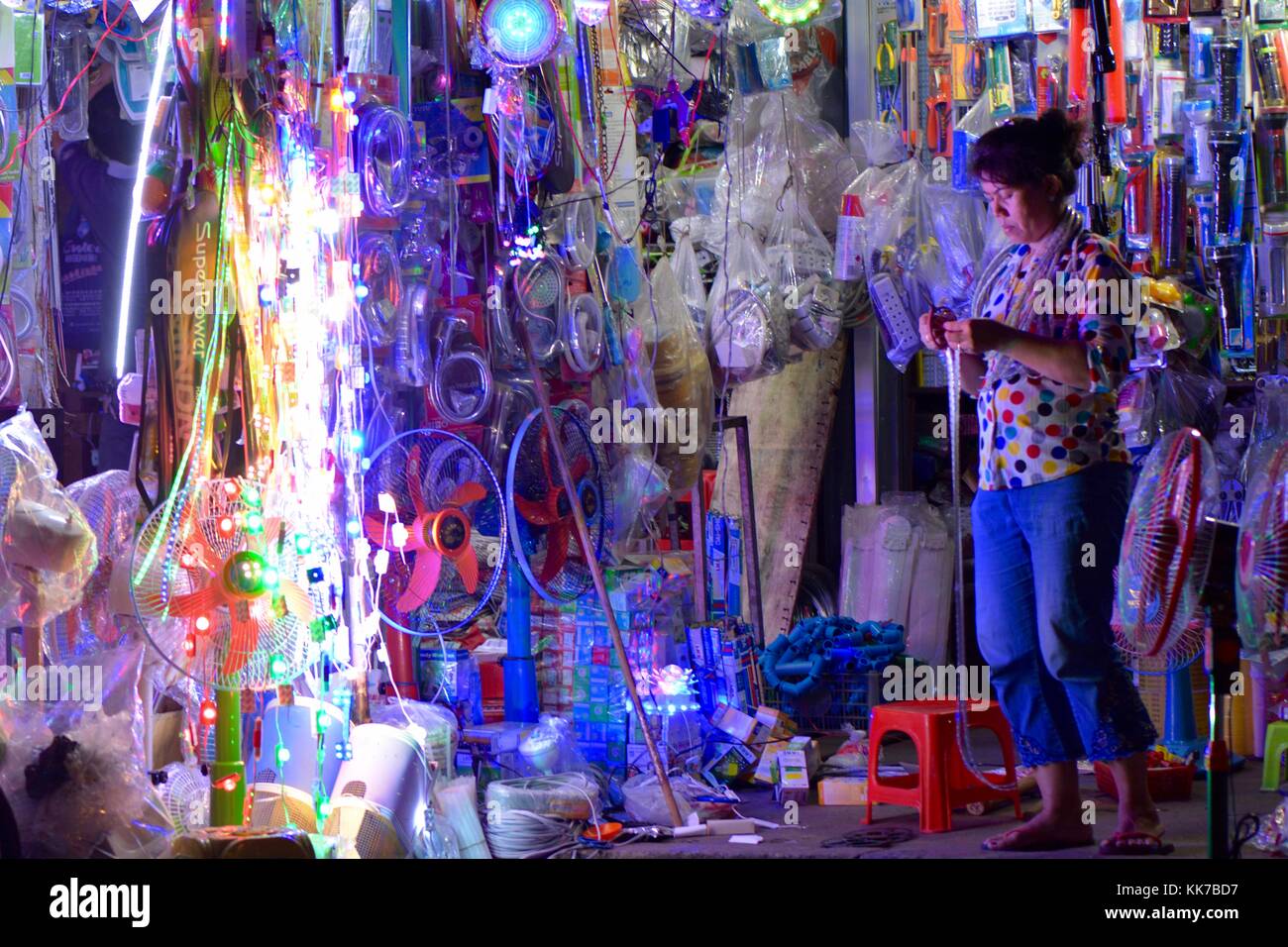 Stallholder in Phnom Penh with electrical goods Stock Photo