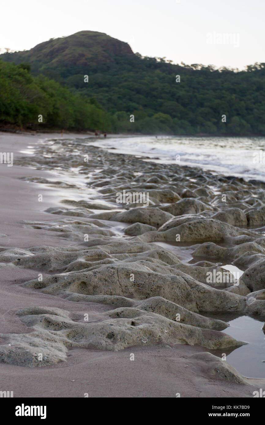 smooth rocky shoreline in Playa Conchal, Costa Rica Stock Photo