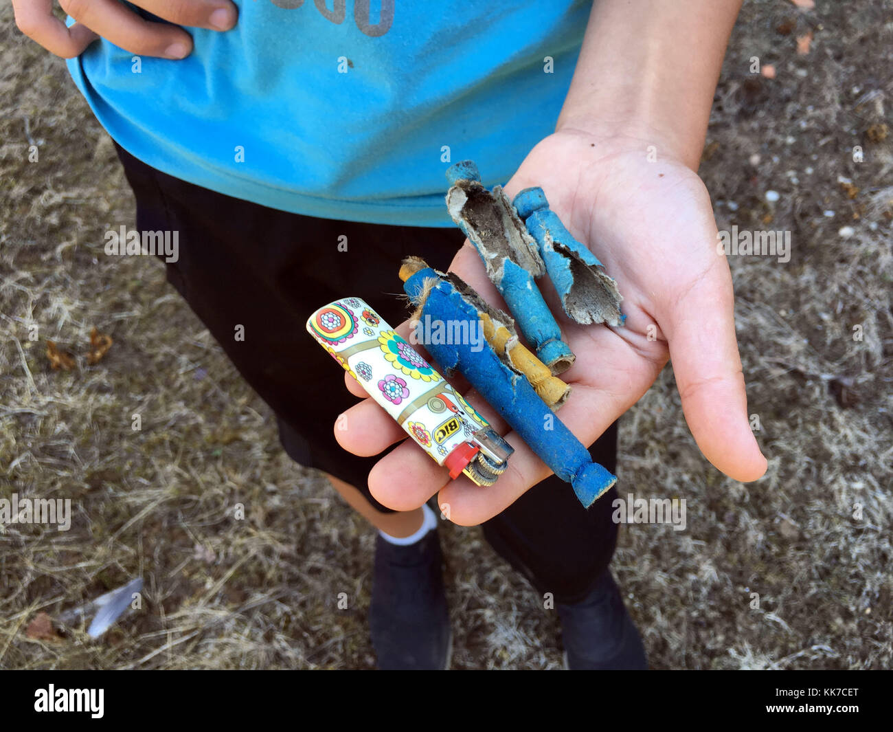 Young boy showing a lighter & used crackers Stock Photo