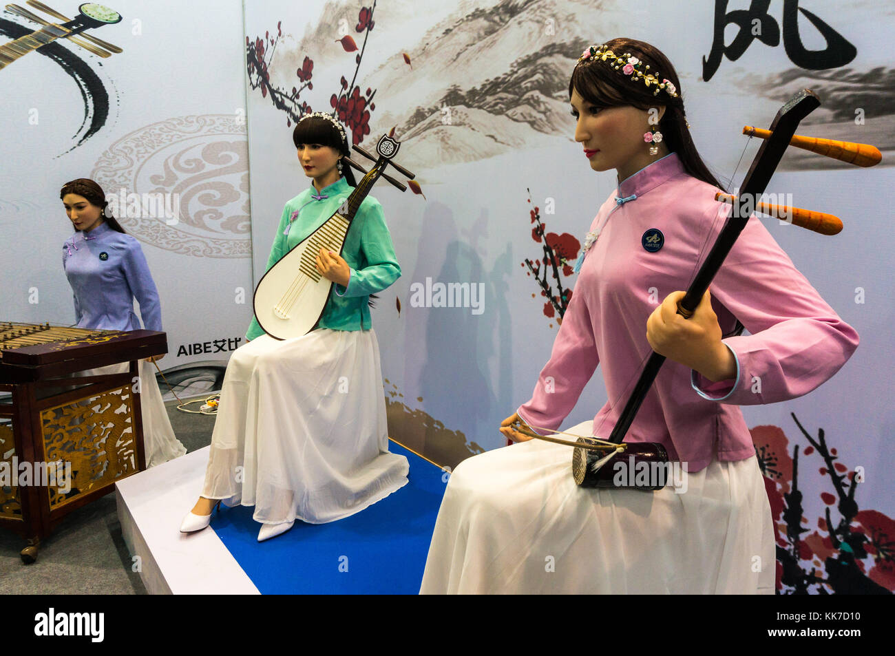 Life-like and attractive humanoid robots playing Chinese musical instruments at a tech fair in Shenzhen, China Stock Photo