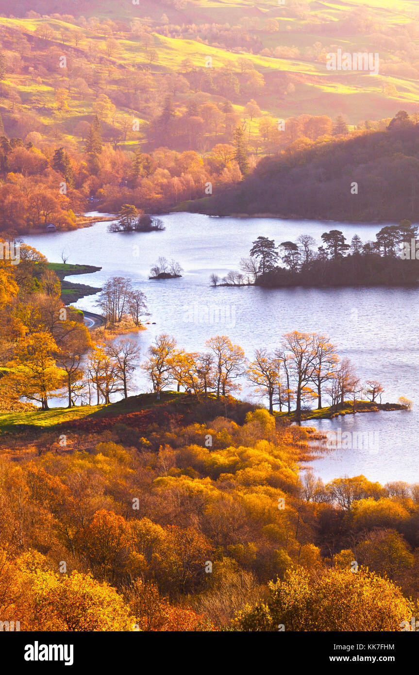 Warm, raking light paints the beautiful autumn landscape at Rydal Water, in the Lake District National Park.,England, UK Stock Photo
