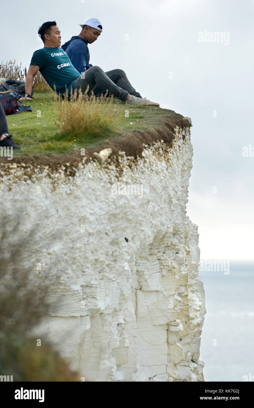 Tourists taking risks on cliff edges to get selfies, Beachy Head, Seven Sisters, East Sussex, UK Stock Photo