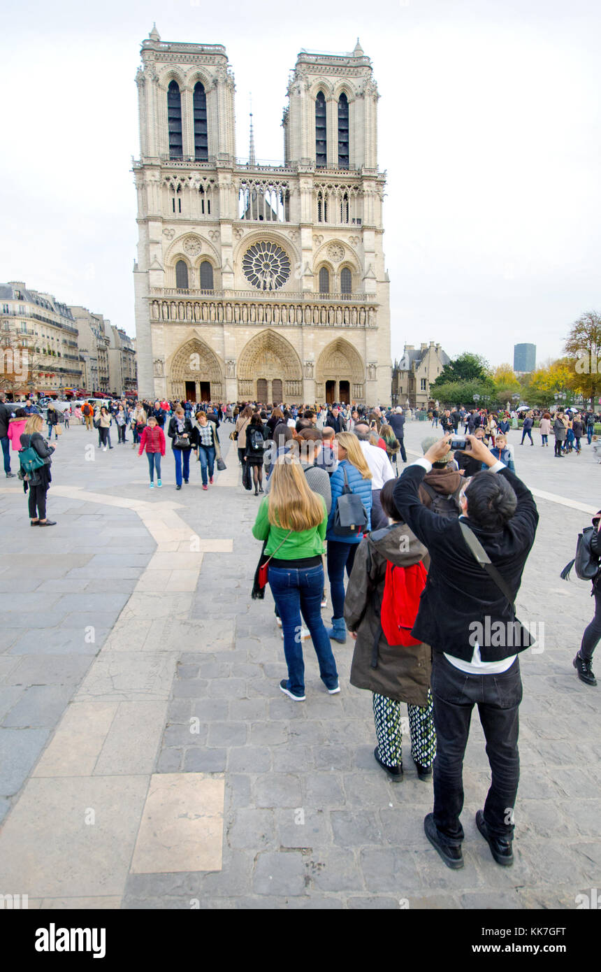 Paris, France. Notre Dame cathedral / Notre-Dame de Paris on Isle de la Cite. Gothic. Long queue of people waiting to get in Stock Photo