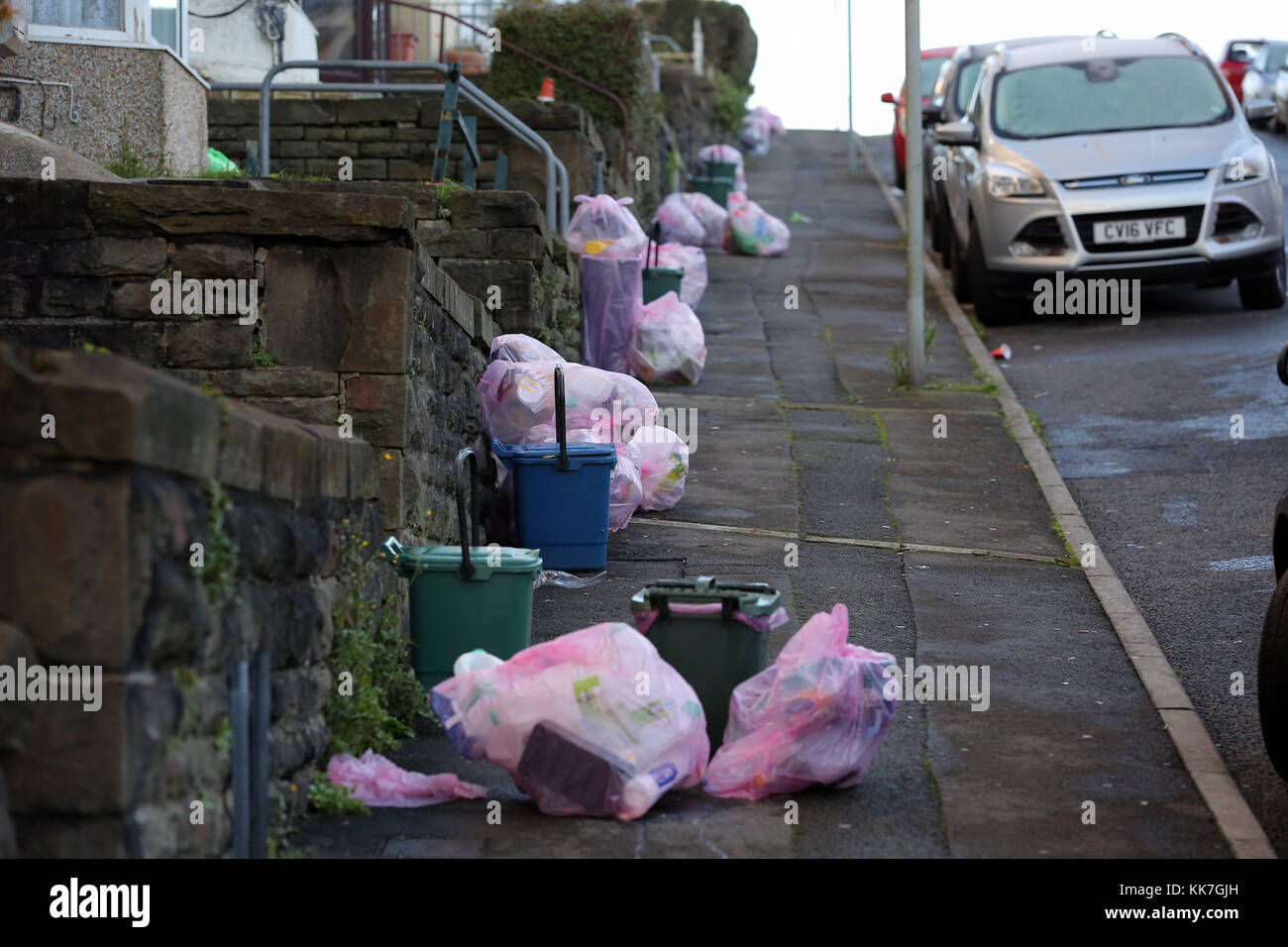 https://c8.alamy.com/comp/KK7GJH/pink-bags-used-for-the-household-recycling-of-plastics-and-bins-used-KK7GJH.jpg