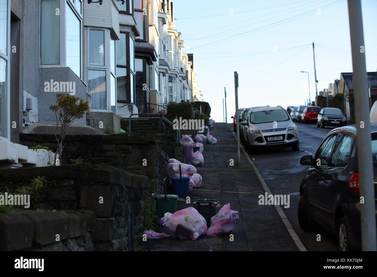 Pink bags used for the household recycling of plastics and bins used