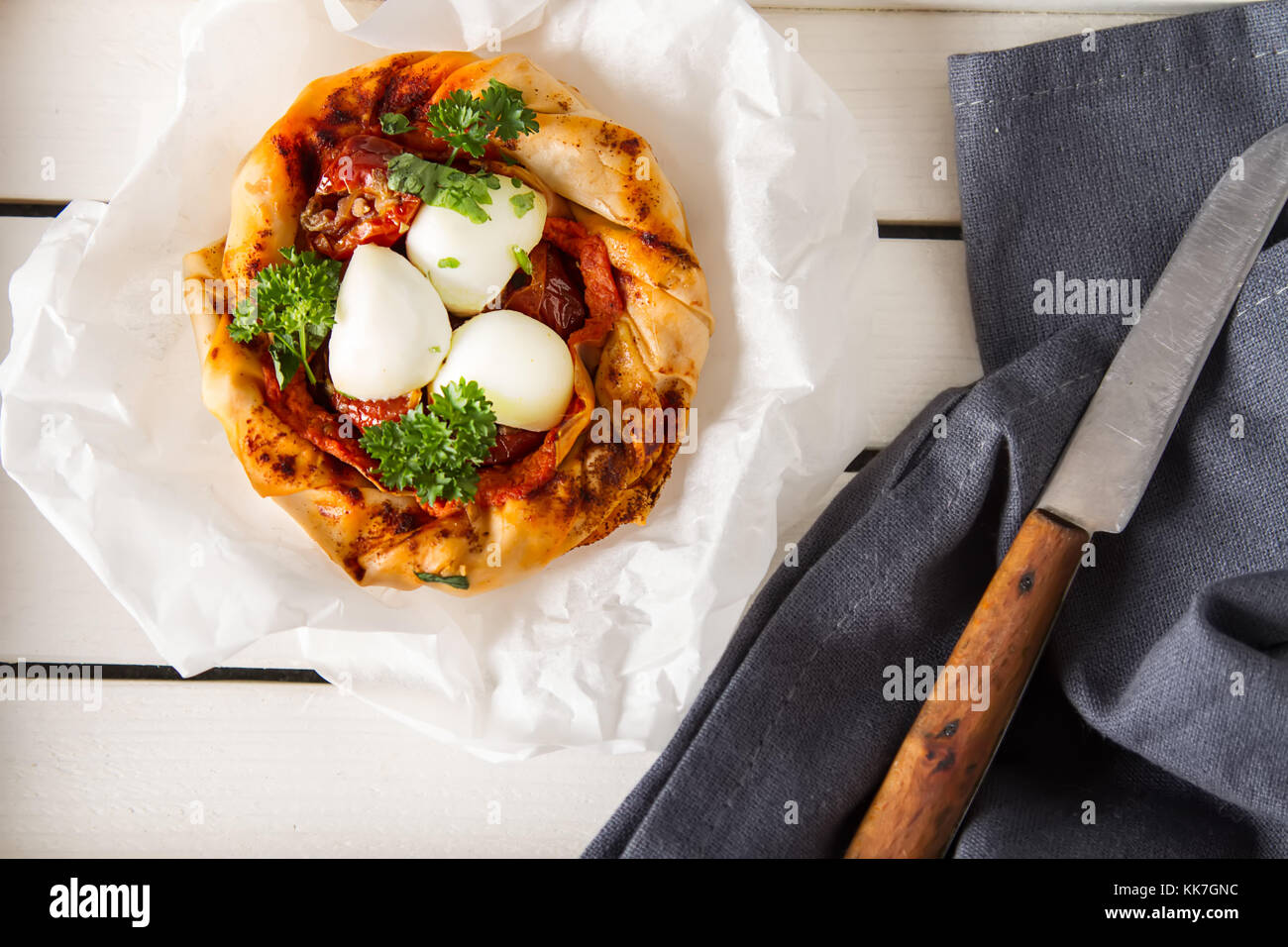 Pie in the oriental style. Filo pastry with tomato and mozzarella