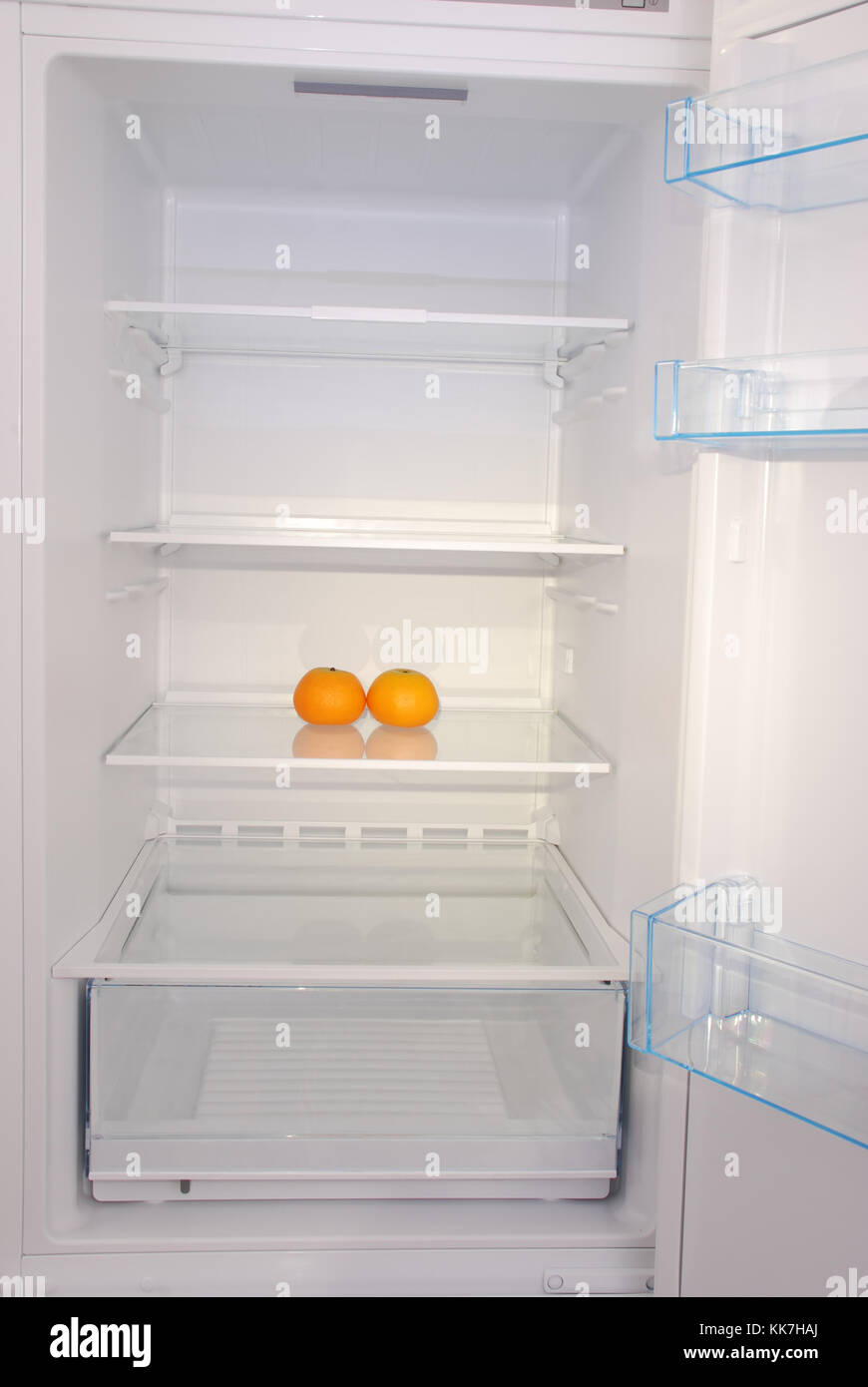 Two mandarins in open empty refrigerator. Weight loss diet concept Stock Photo Alamy