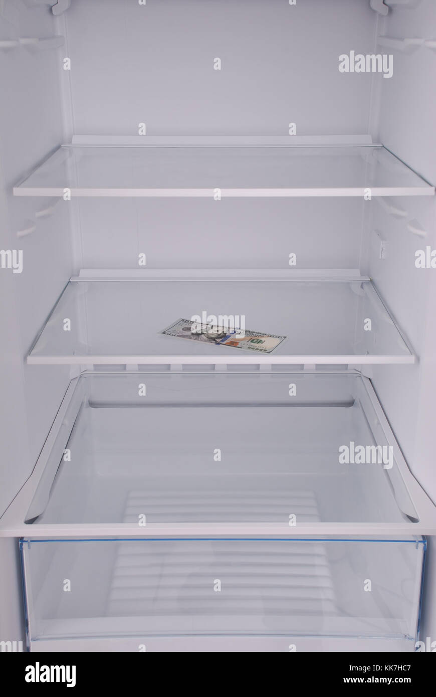 Dollars inside in empty clean refrigerator with opened door Stock Photo