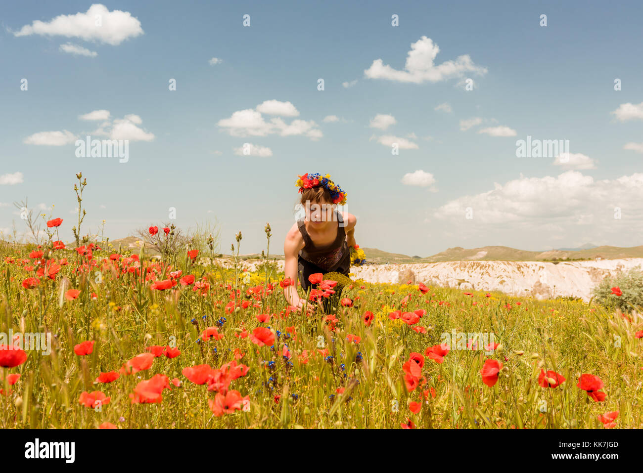 Teen girl in poppy field outdoor Stock Photo