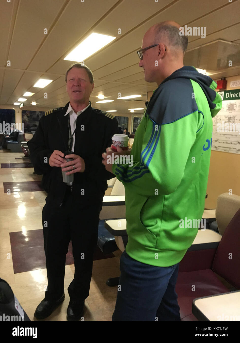 Capt. Fee of our ferry Wenatchee and Sounders legend Kasey Keller chat Thursday during the Bainbridge Island-Seattle run. Sharing stories 38118274241 o Stock Photo