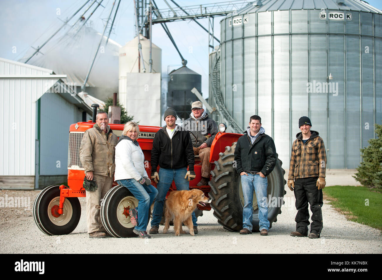 THREE GENERATIONS FAMILY PORTRAIT ON THEIR CLASSIC ALLIS-CHALMERS TRACTOR ON THEIR FARM IN BLOOMING PRAIRIE, MINNESOTA. Stock Photo