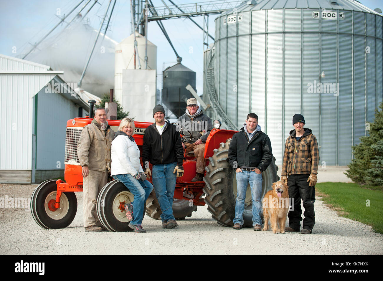 THREE GENERATIONS FAMILY PORTRAIT ON THEIR CLASSIC ALLIS-CHALMERS TRACTOR ON THEIR FARM IN BLOOMING PRAIRIE, MINNESOTA. Stock Photo