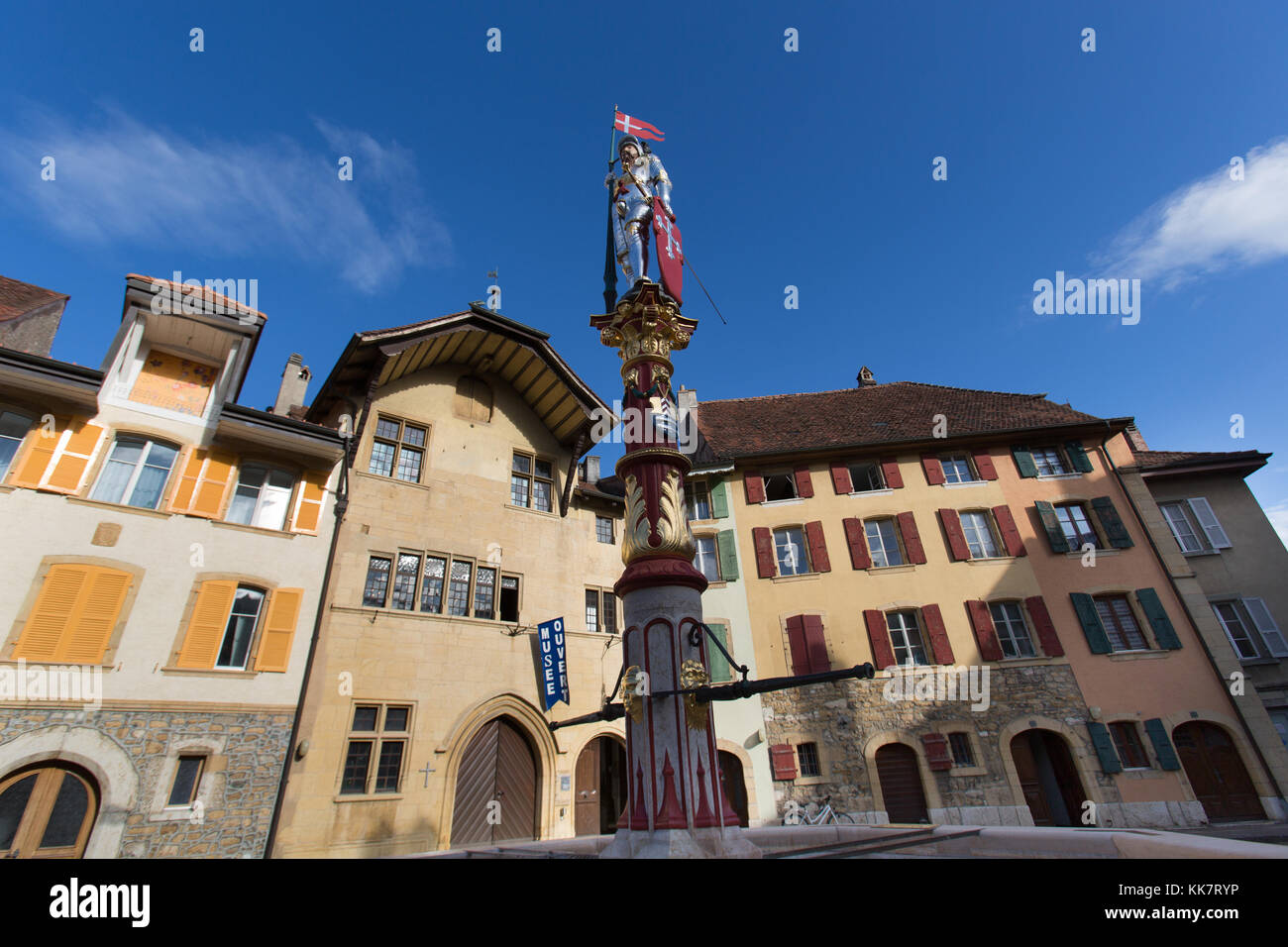 Town of Le Landeron, Switzerland. Picturesque view of the statue on top of the fountain of Saint Maurice, in the medieval Old Town of Le Landeron. Stock Photo