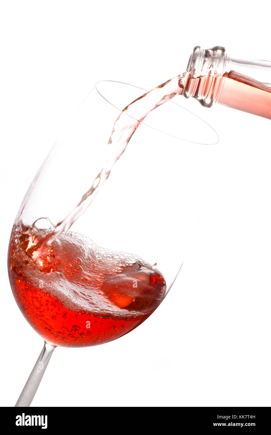 Pouring rose wine into a glass isolated on white background Stock Photo ...