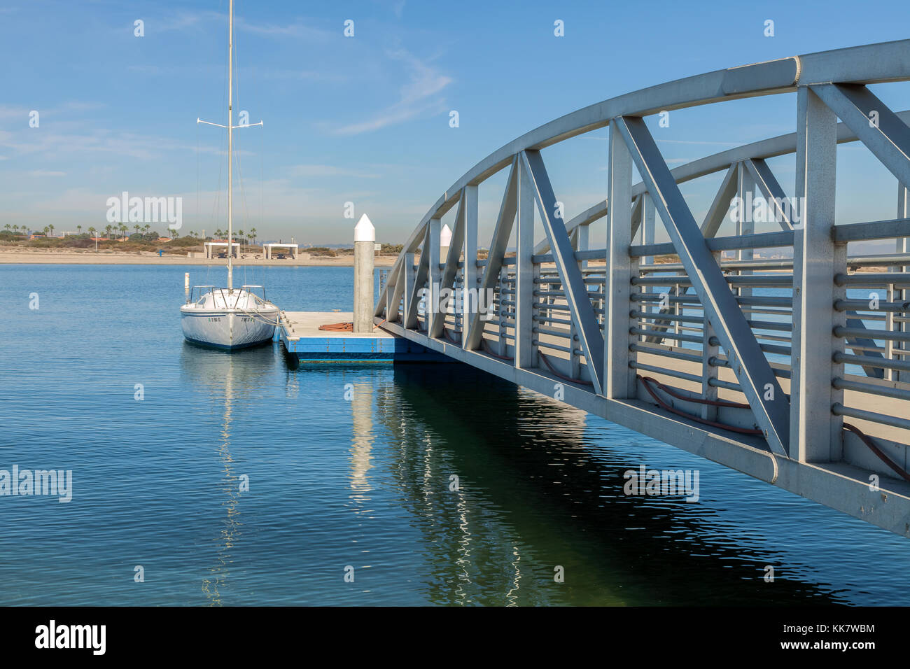 Small bridge connecting to a dock with docked boat, Coronado Bay, California, USA. Stock Photo