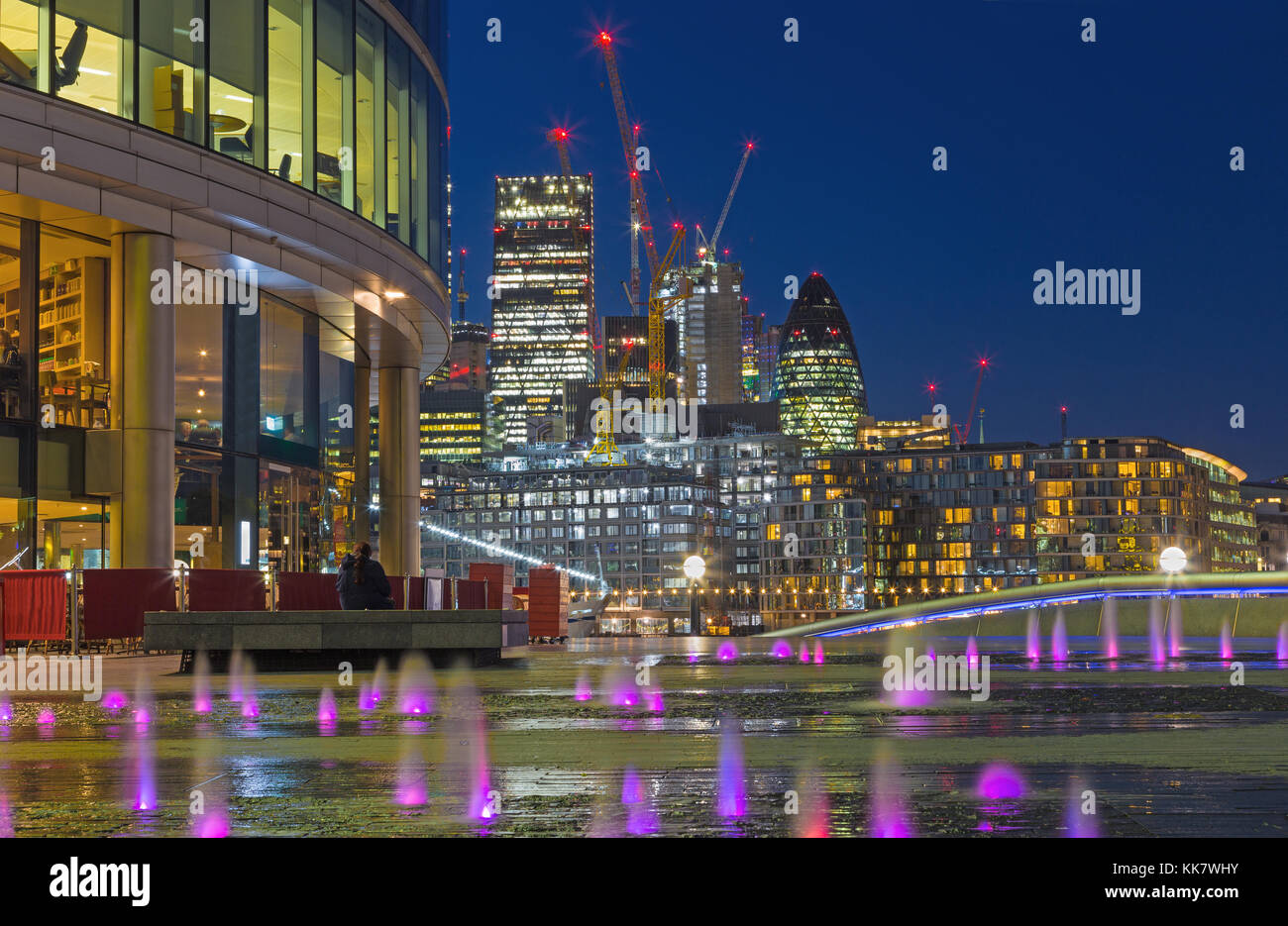 LONDON, GREAT BRITAIN - SEPTEMBER 19, 2017: The view from More London riverside across the fountian to skyscrapers in the center at dusk. Stock Photo