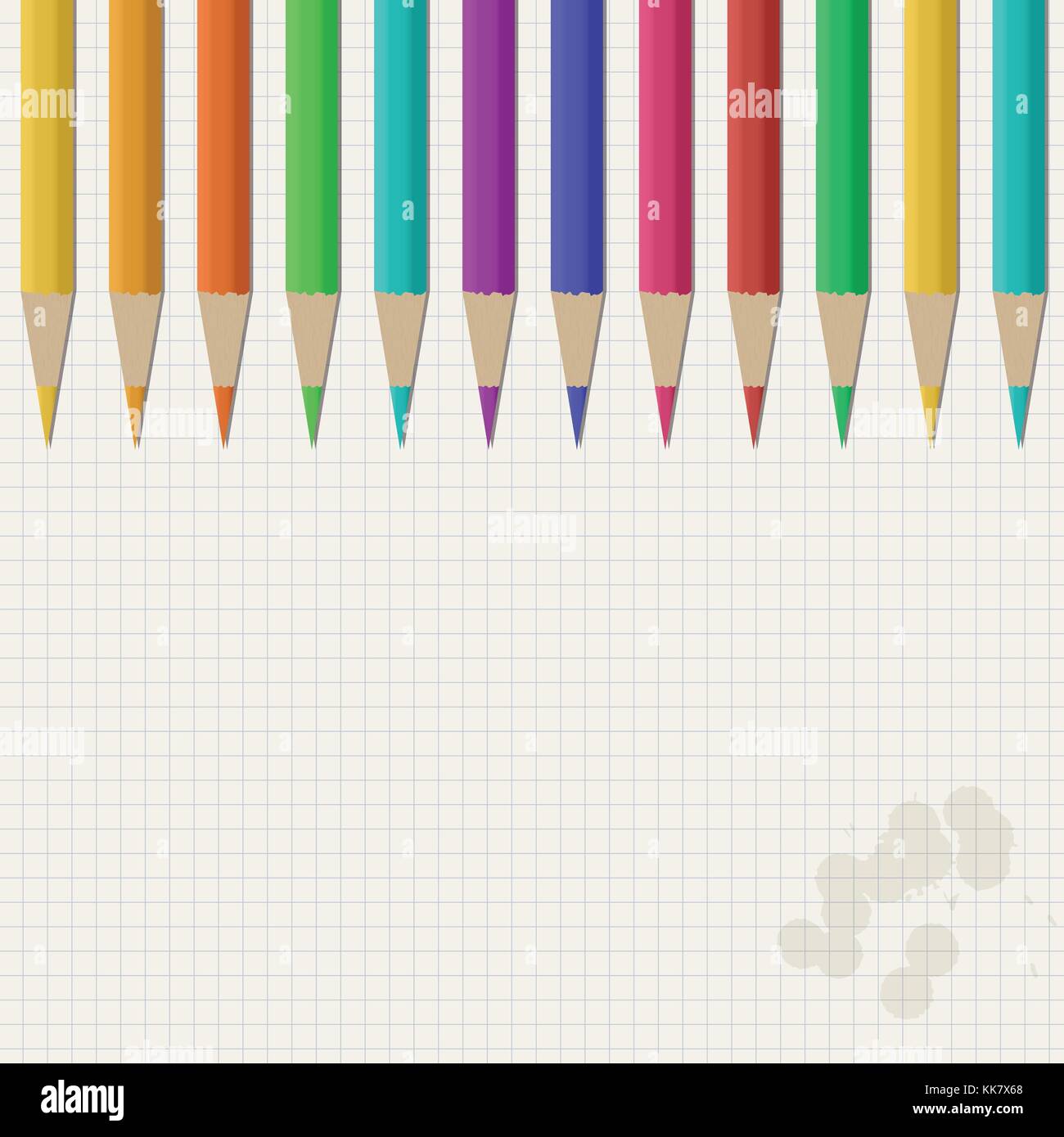 White squared stained notebook paper with colorful pencils on top for ...