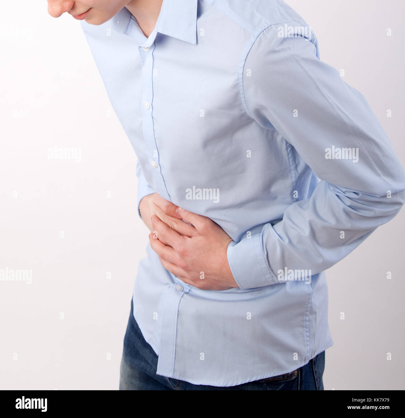teenage boy with stomach pain Stock Photo