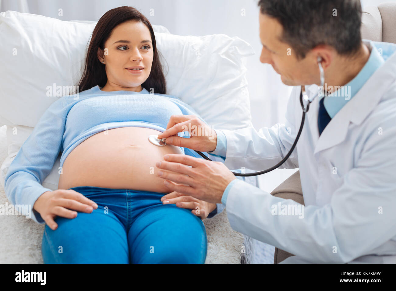 Cheerful pregnancy lying on the couch in clinic Stock Photo Alamy