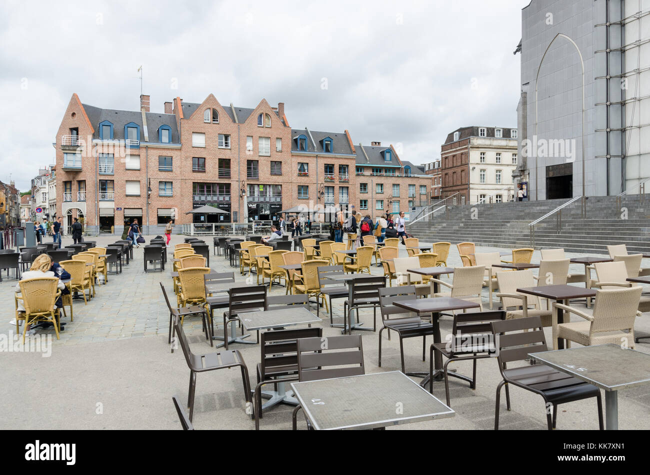 Rows of tables and chairs at a cafe outside the Notre Dame Cathedral in lille, France Stock Photo