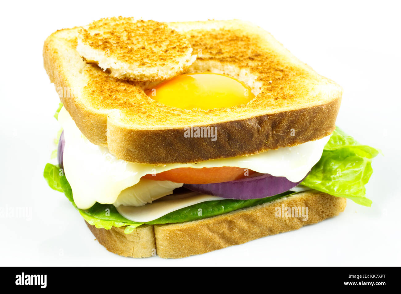 Sandwich of turkey with a fried egg inside it, with a hole in bread