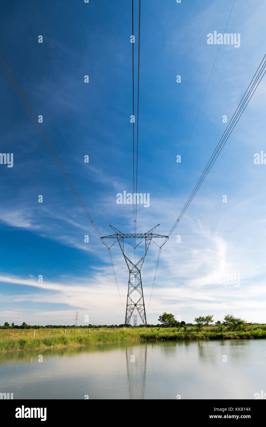 high voltage pole with white cloudy and blue sky Stock Photo - Alamy