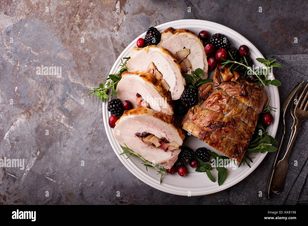 Roasted pork loin stuffed with apple and cranberry Stock Photo