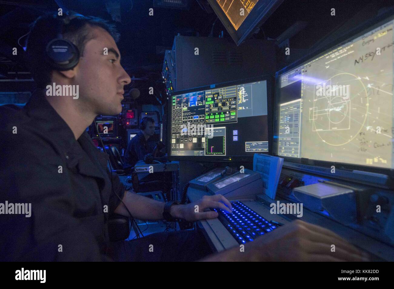 Lt jg Michael Cornish, from Omaha, Neb, stands watch in the combat information center aboard the guided-missile cruiser USS Normandy CG 60 during an air-defense exercise as a part of the joint exercise Malabar 2015, U.S. 7Th Fleet Area Of Operations. Image courtesy Mass Communication Specialist 3rd Class Justin R. DiNiro/US Navy, 2015. Stock Photo