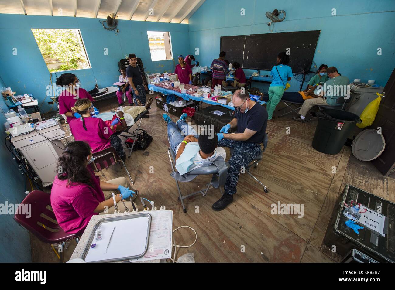 Sailors and non-governmental organization volunteers assigned to the Military Sealift Command hospital ship USNS Comfort T-AH 20 perform dental procedures on patients at a medical site established at the Dominica Grammar School in support of Continuing Promise 2015, Roseau, Dominica. Image courtesy Mass Communication Specialist 2nd Class Derek Paumen/US Navy, 2015. Stock Photo