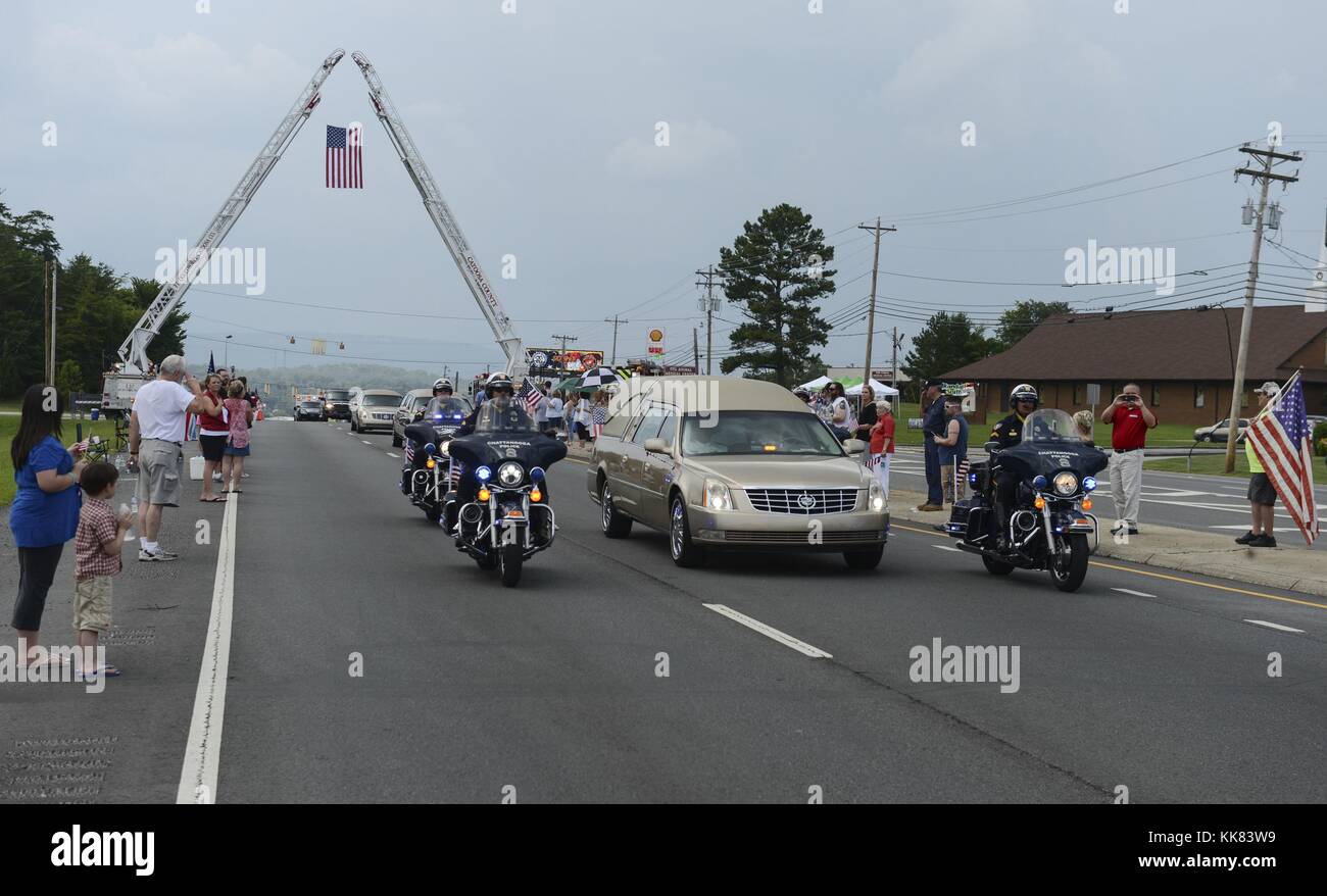 The hearse carrying the remains of Logistics Specialist 2nd Class Randall Smith is escorted to Chattanooga National Cemetery after his funeral service at First Baptist Church in Fort Oglethorpe, Georgia. Smith died July 18 from injuries suffered in a shooting at Navy Operational Support Center NOSC Chattanooga that also killed four Marines. Image courtesy Mass Communication Specialist 1st Class Dustin Q. Diaz/US Navy, 2015. Stock Photo