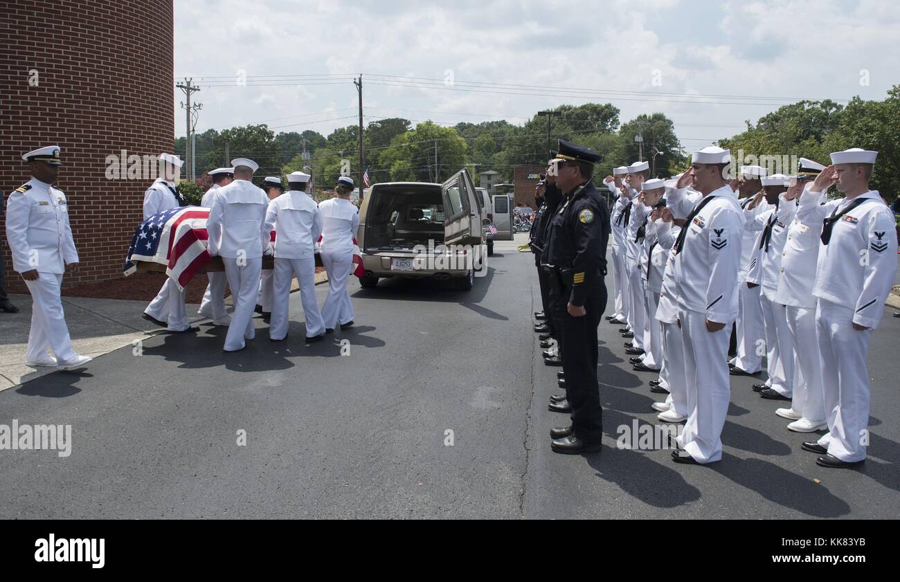 Police officers and Sailors render honors as the remains of Logistics Specialist 2nd Class Randall Smith are placed into a hearse after a service at First Baptist Church in Fort Oglethorpe, Georgia. Image courtesy Chief Mass Communication Specialist Michael D. Cole/US Navy, 2015. Stock Photo