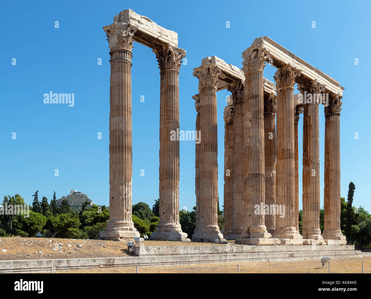 The Temple of Olympian Zeus (Olympeion) with Mount Lycabettus (Lykavittos Hill) in the background, Athens, Greece Stock Photo