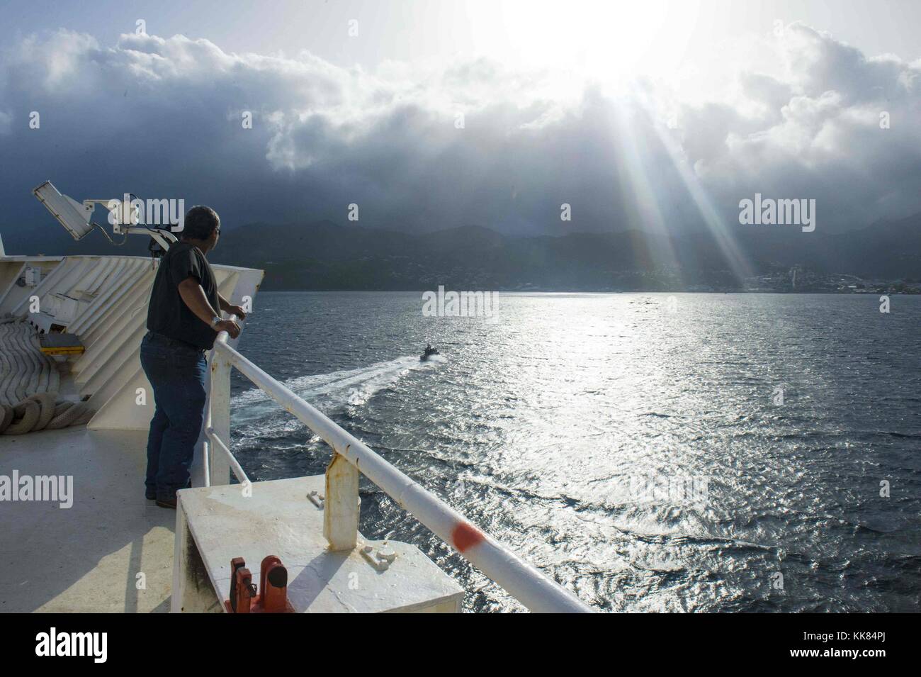 Deck mechanic Donald Rodriguez, a Military Sealift Command civil service mariner, watches as the hospital ship USNS Comfort T-AH 20 arrives in Roseau, Dominica during Continuing Promise 2015, Roseau, Dominica. Image courtesy Mass Communication Specialist 2nd Class Brittney Cannady/US Navy, 2015. Stock Photo
