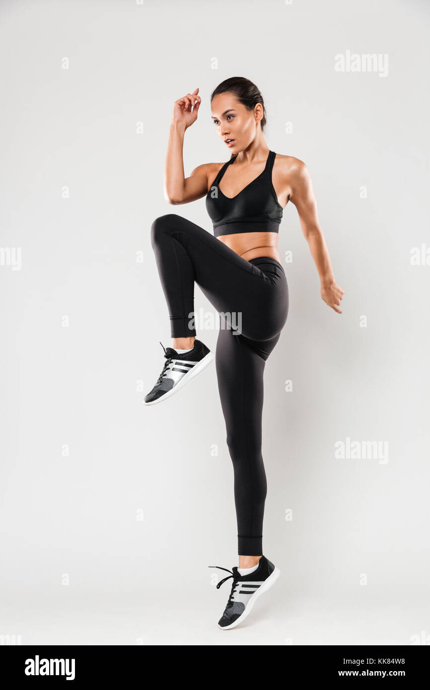 Photo of beautiful young sports lady make sports exercises isolated ...