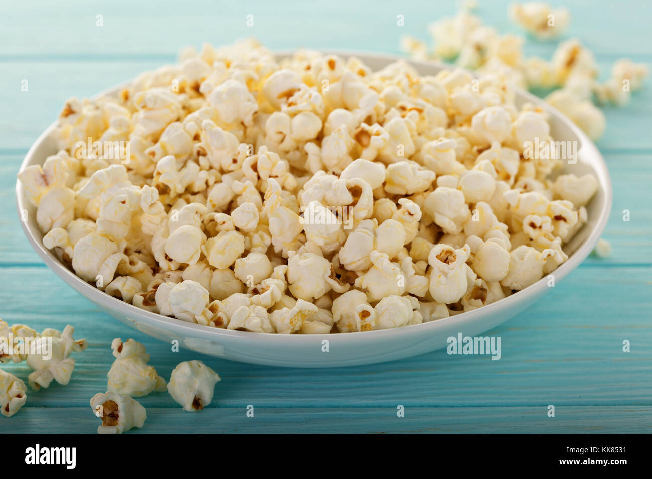 Cheddar cheese popcorn in a white bowl Stock Photo