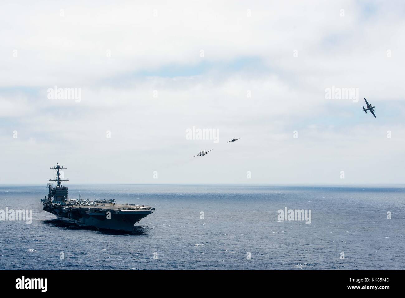 An E2-C Hawkeye piloted by Cmdr Matthew Duffy, from Kenilworth, Illinois, breaks formation turning over the Golden Hawks of Airborne Early Warning Squadron VAW 112 to Cmdr Paul Flores, from Jacksonville, Florida, during an aerial change of command ceremony above the aircraft carrier USS John C. Stennis CVN 74. Image courtesy Mass Communication Specialist 3rd Class Andre T. Richard/US Navy, 2015. Stock Photo