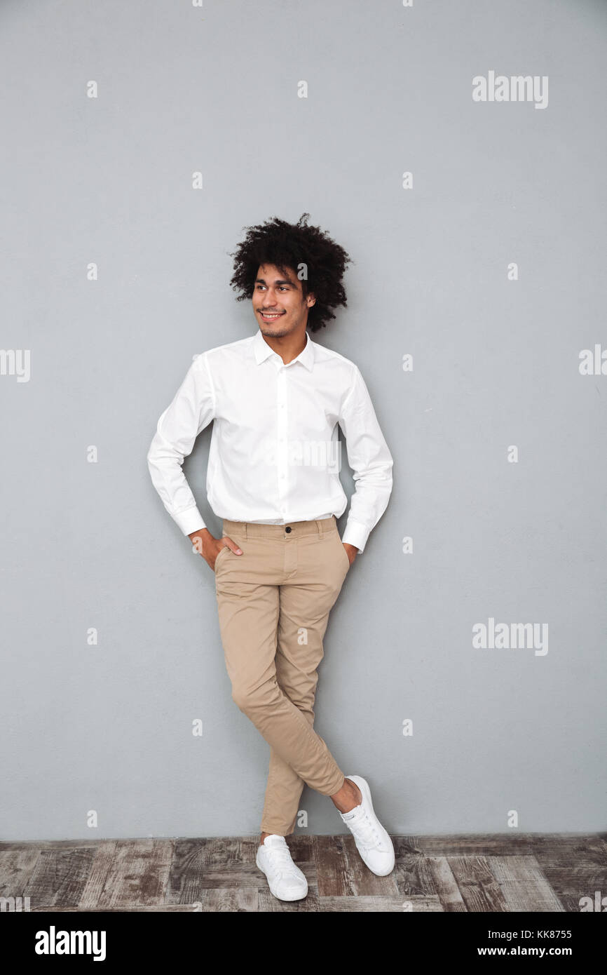 Full length portrait of a confident smiling african man in white shirt ...