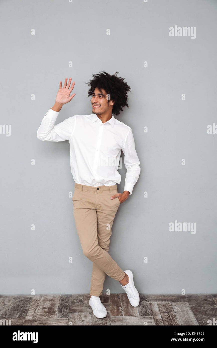 Full length portrait of a young smiling african man in white shirt ...