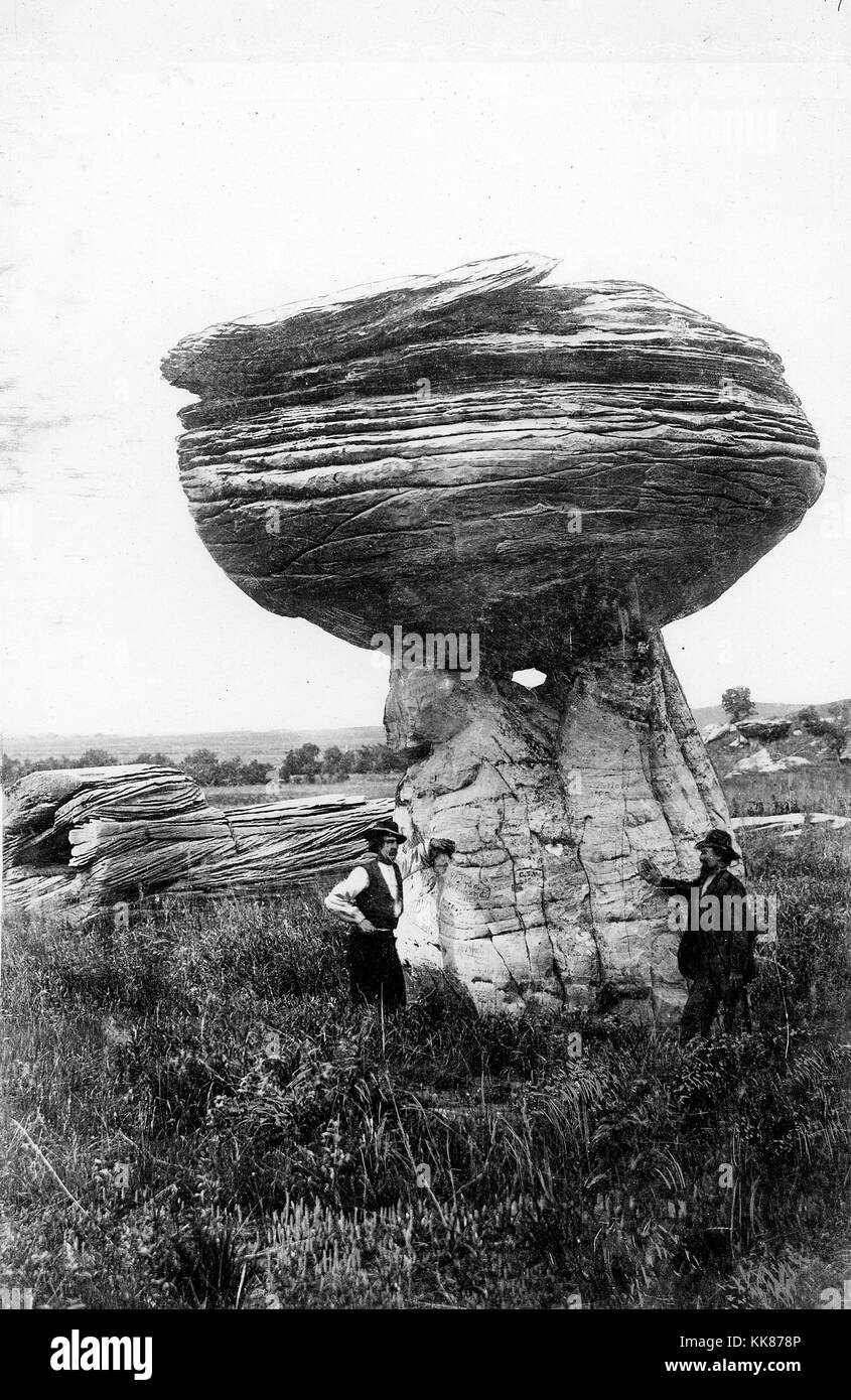 Pulpit rock near Alum Creek south of Carneiro, in Ellsworth County, Kansas, which is a hard mass of Dakota sandstone that has resisted erosion better than the underlying softer bed that forms its pedestal. Image courtesy USGS. 2015. Stock Photo