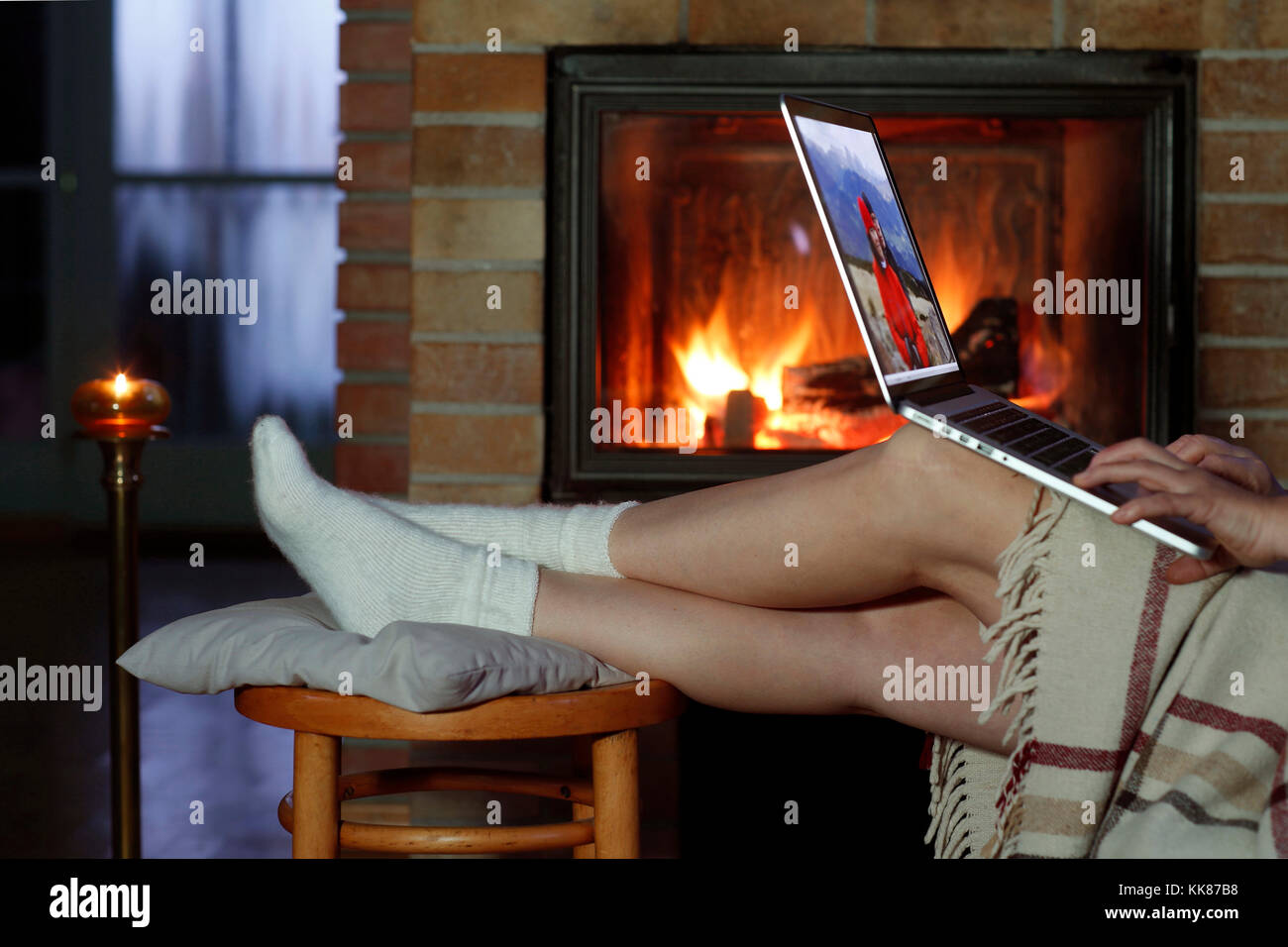 Female Legs, Rest by the Fireplace, Fireplace, Laptop, Work, Hands on the Keyboard, Relax Stock Photo