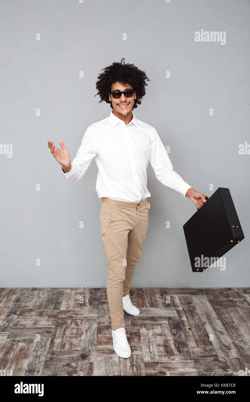 Full length portrait of a young confident african man in white shirt ...