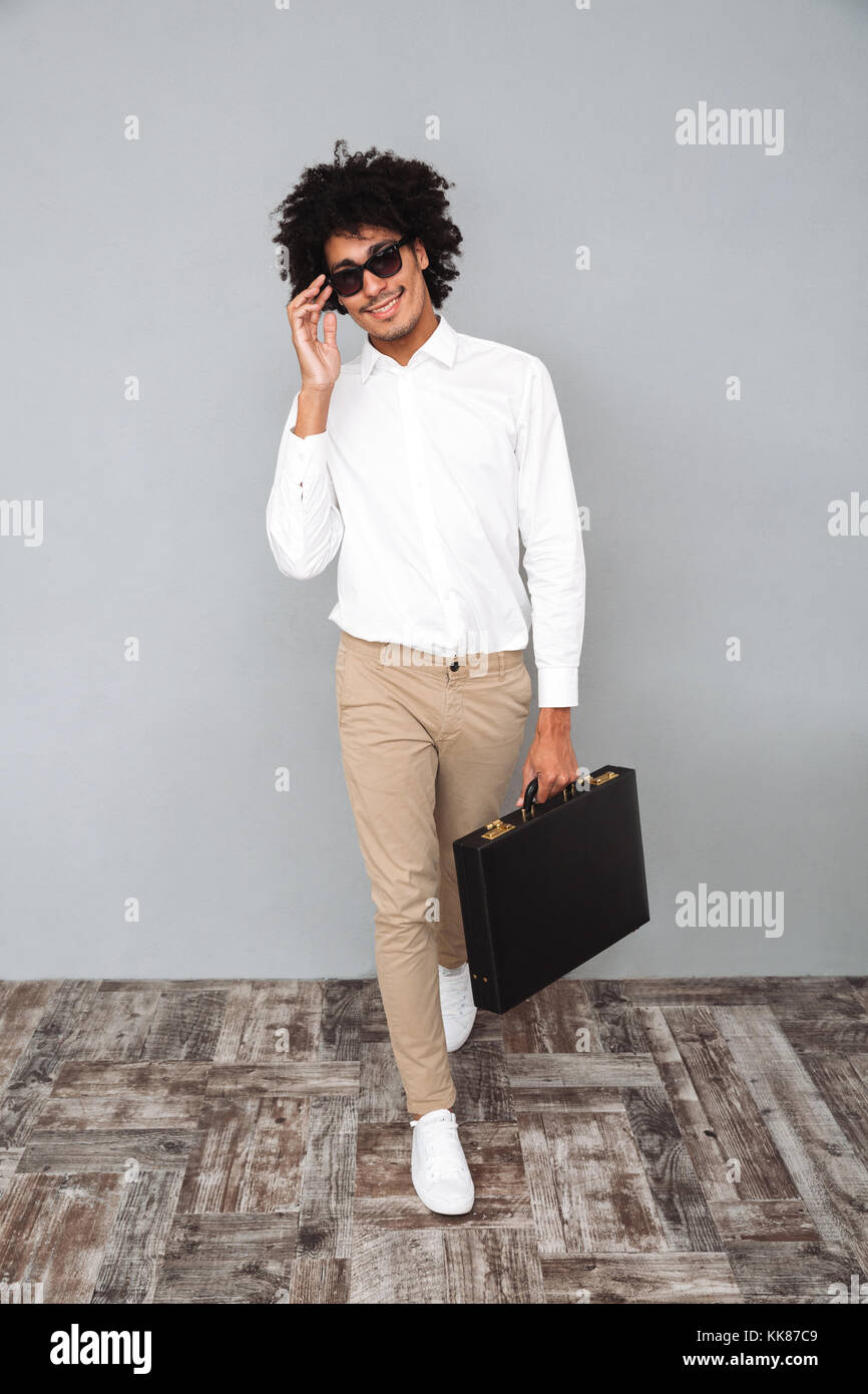 Full length portrait of a confident smiling african man in white shirt ...