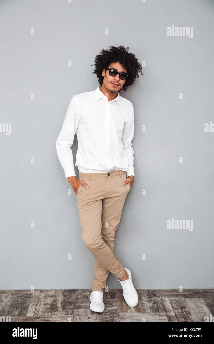 Full length portrait of a confident smiling african man in white shirt ...